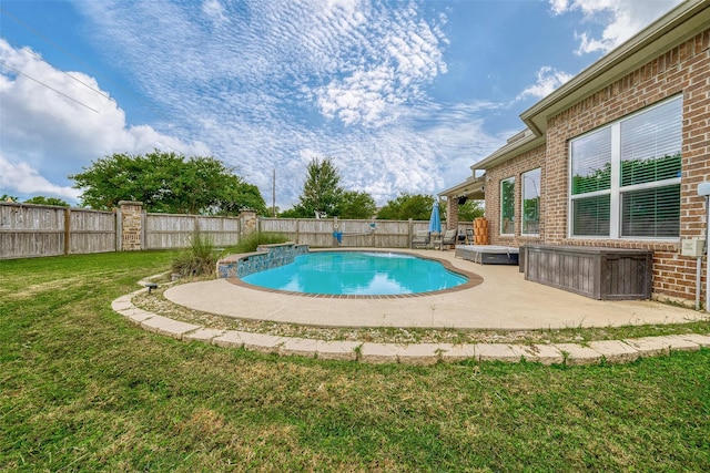 view of pool featuring a yard and a patio