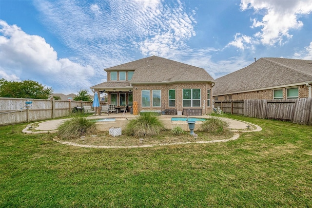 back of house with a lawn, a patio area, and a fenced in pool