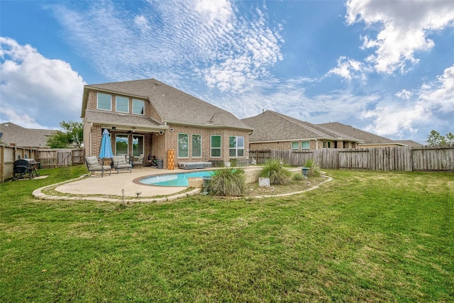 back of house featuring a fenced in pool, a yard, and a patio