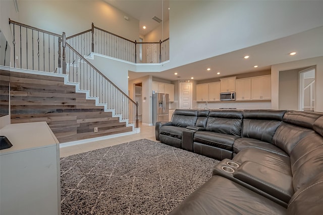 tiled living room featuring a high ceiling