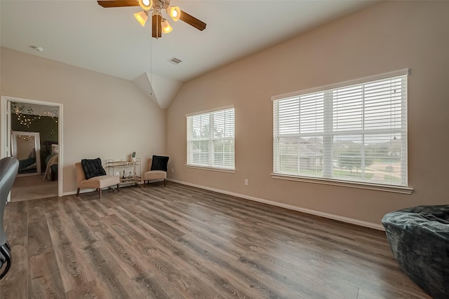 living area featuring hardwood / wood-style flooring, ceiling fan, and lofted ceiling