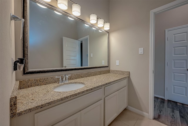 bathroom with vanity and hardwood / wood-style flooring