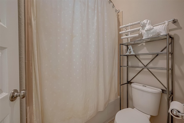 bathroom with shower / bath combo and toilet