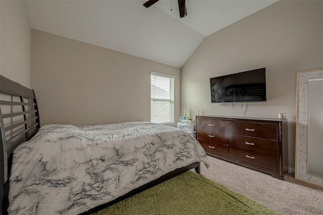 carpeted bedroom with ceiling fan and vaulted ceiling