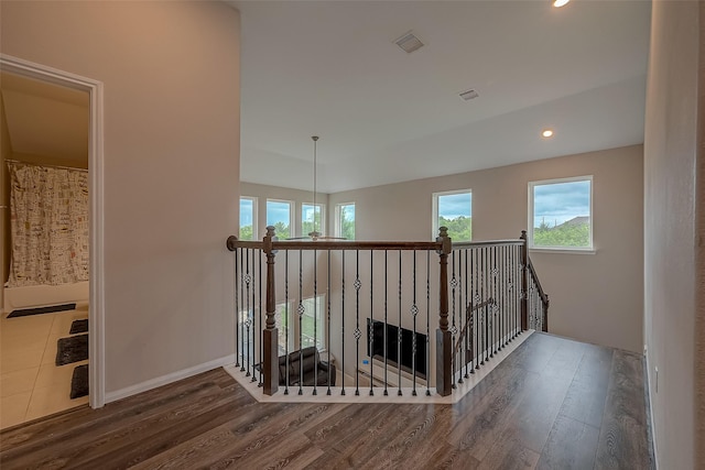 hall featuring hardwood / wood-style floors and a notable chandelier