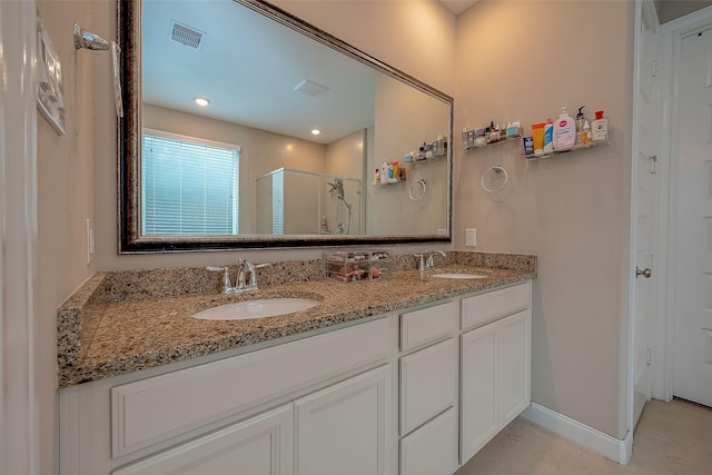 bathroom with tile patterned floors, vanity, and a shower with shower door