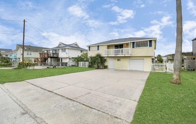 view of front of property with a front yard, a balcony, and central AC unit