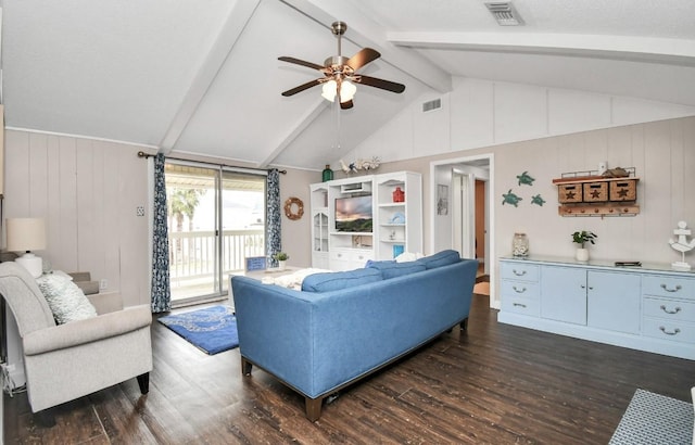 living room featuring lofted ceiling with beams, wooden walls, ceiling fan, and dark wood-type flooring