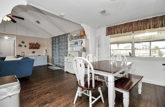 dining room with a textured ceiling, vaulted ceiling with beams, dark hardwood / wood-style floors, and ceiling fan