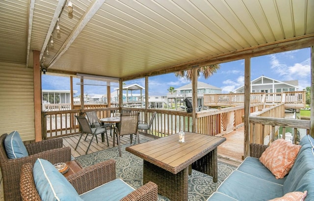 sunroom featuring a wealth of natural light and wooden ceiling