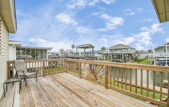 wooden terrace with a sunroom and a water view