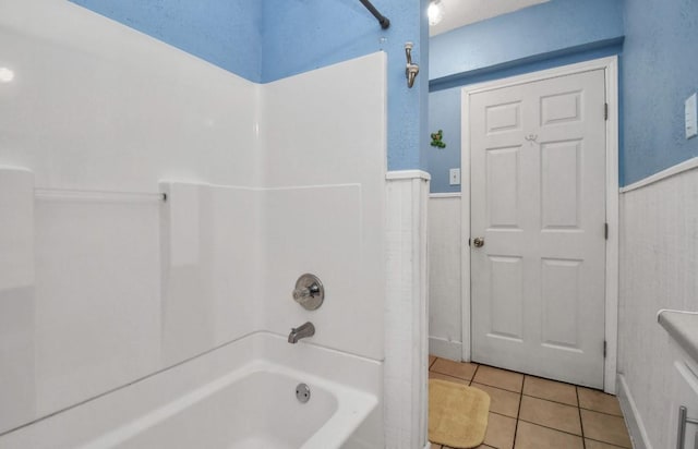 bathroom with tile patterned floors and  shower combination