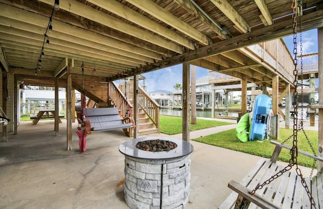 view of patio featuring a water view and a fire pit