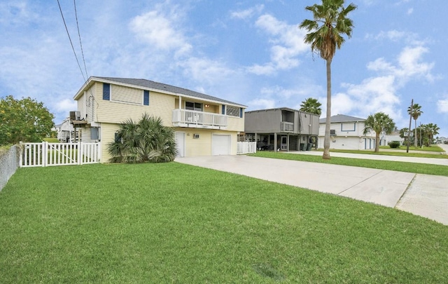 view of front of property with a balcony, a garage, and a front lawn