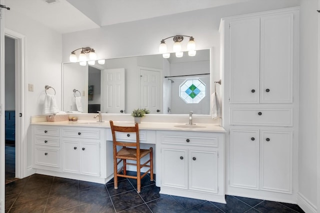 full bathroom featuring double vanity, walk in shower, a sink, and tile patterned floors