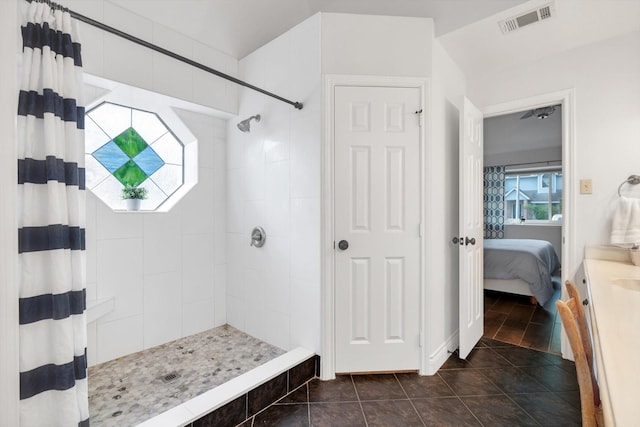 ensuite bathroom with tiled shower, plenty of natural light, connected bathroom, and visible vents