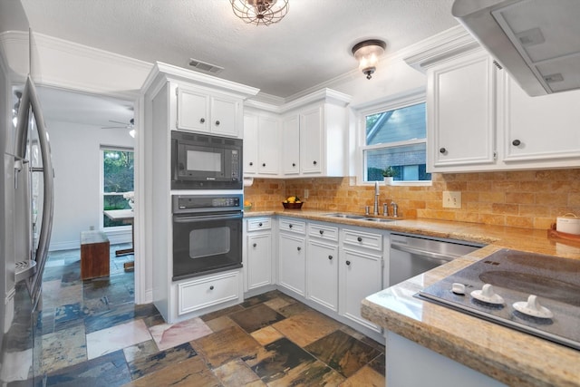 kitchen with sink, exhaust hood, black appliances, white cabinets, and backsplash