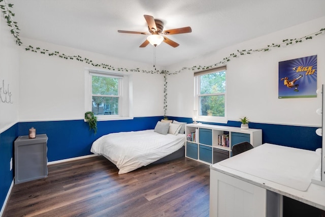 bedroom with baseboards, a ceiling fan, and wood finished floors