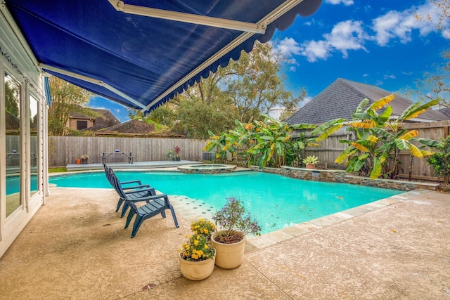 view of swimming pool featuring an in ground hot tub and a patio