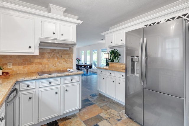 kitchen featuring under cabinet range hood, appliances with stainless steel finishes, white cabinets, and stone tile flooring