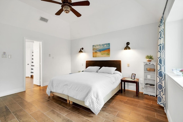 bedroom featuring wood tiled floor, visible vents, baseboards, and ceiling fan