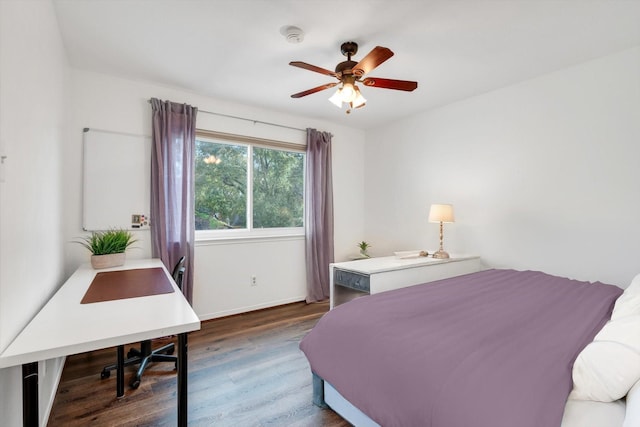 bedroom featuring ceiling fan, baseboards, and wood finished floors