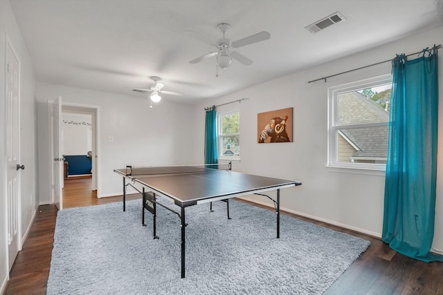 recreation room with dark wood-type flooring