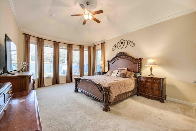 carpeted bedroom featuring ceiling fan and crown molding