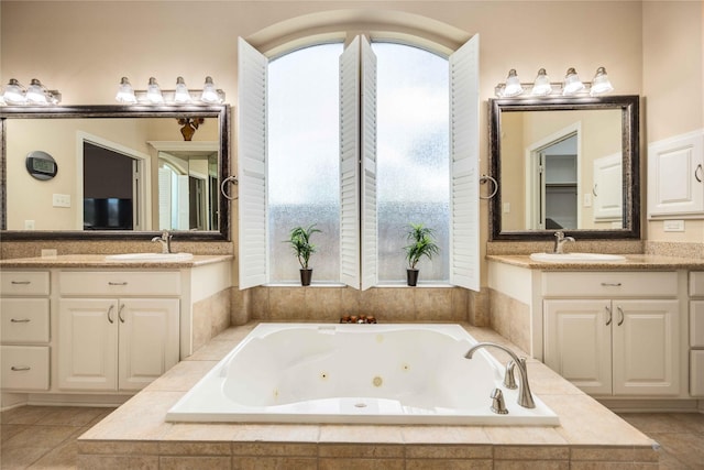 bathroom featuring vanity and a relaxing tiled tub