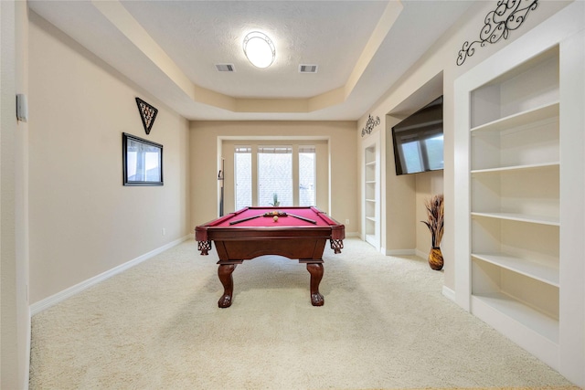 playroom with carpet, a textured ceiling, a tray ceiling, built in features, and pool table