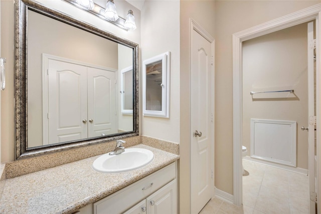 bathroom with tile patterned floors, vanity, and toilet