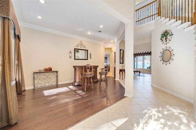 dining space featuring ornate columns, crown molding, and light tile patterned floors