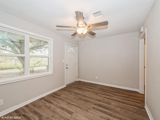 unfurnished room featuring ceiling fan and dark hardwood / wood-style floors