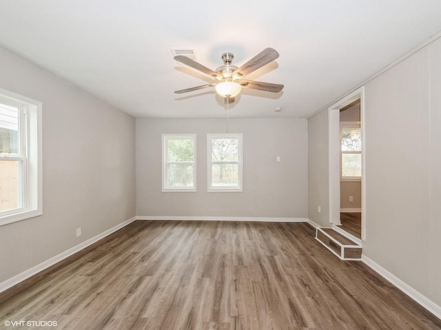 unfurnished room featuring ceiling fan and hardwood / wood-style flooring