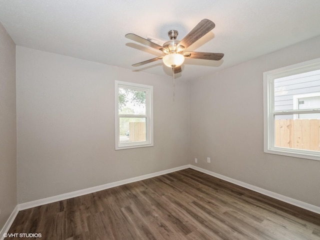 unfurnished room with ceiling fan and dark hardwood / wood-style floors