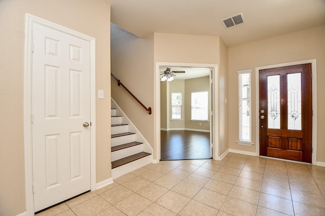 foyer entrance with light tile patterned floors and ceiling fan