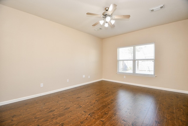 spare room with dark hardwood / wood-style floors and ceiling fan