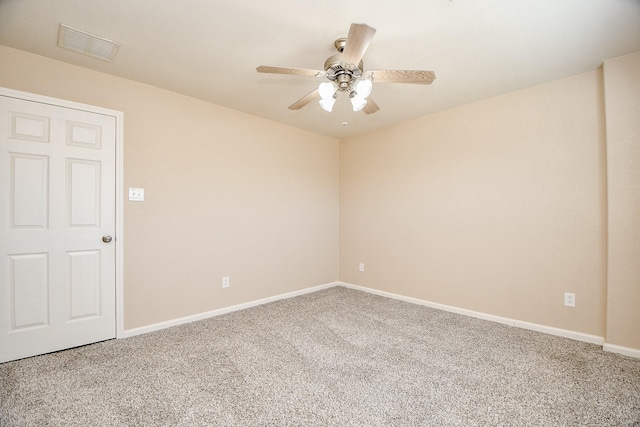 spare room featuring carpet and ceiling fan