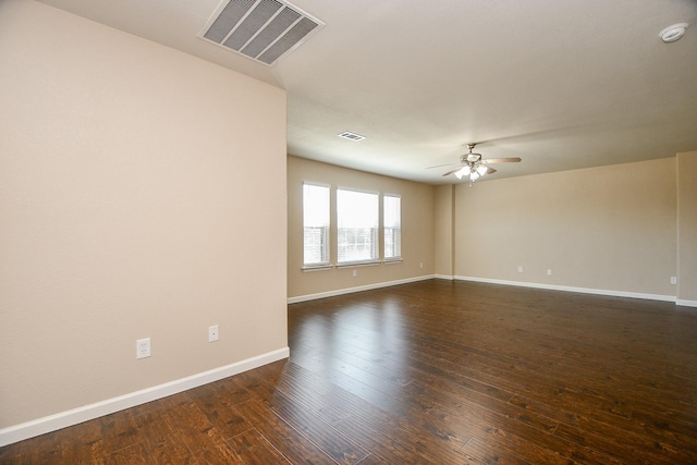 empty room with ceiling fan and dark wood-type flooring