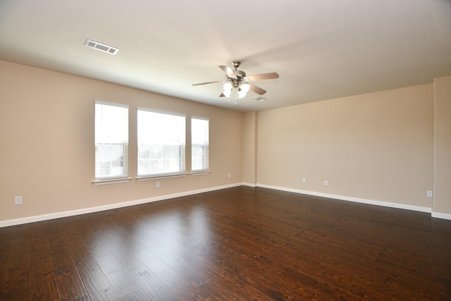 spare room with ceiling fan and dark hardwood / wood-style flooring