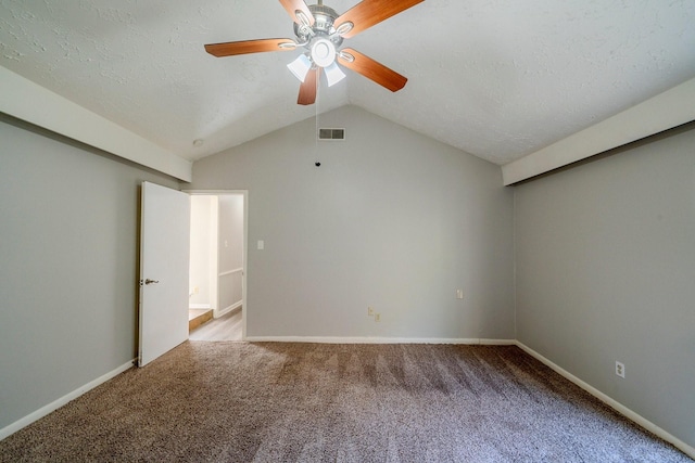 unfurnished bedroom with a textured ceiling, ceiling fan, lofted ceiling, and light carpet