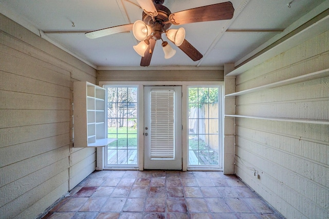 entryway with wood walls and ceiling fan