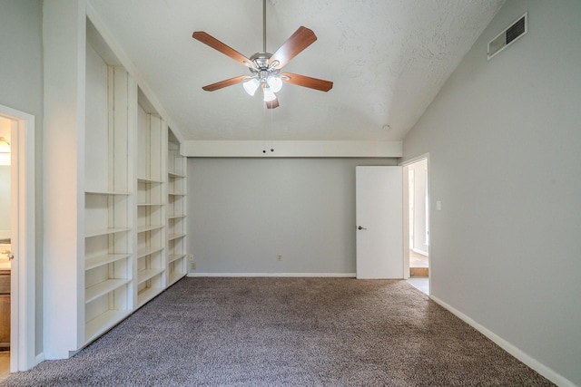 unfurnished bedroom featuring carpet, a textured ceiling, ceiling fan, connected bathroom, and lofted ceiling