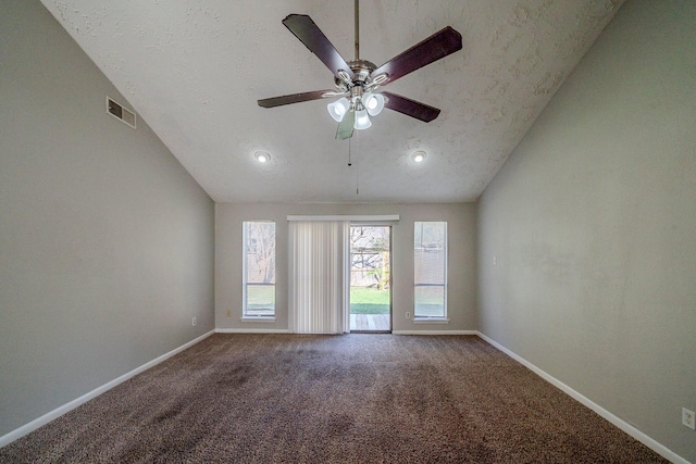 spare room with a textured ceiling, ceiling fan, carpet, and lofted ceiling