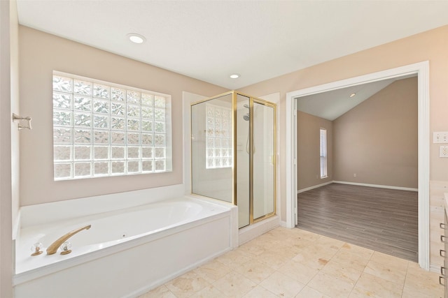 bathroom with lofted ceiling, hardwood / wood-style flooring, and independent shower and bath