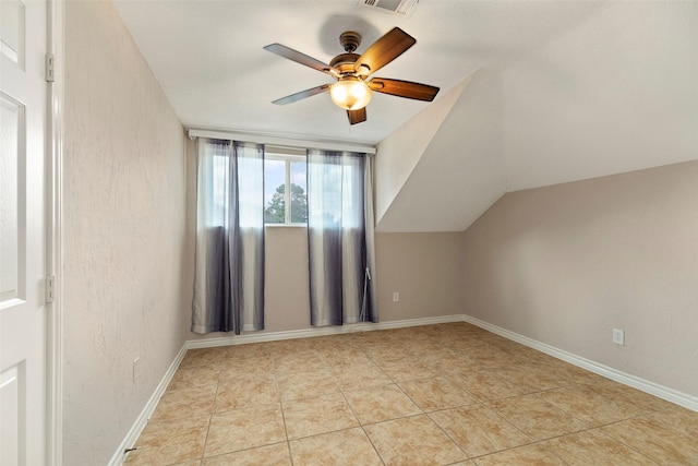 bonus room featuring light tile patterned floors, vaulted ceiling, and ceiling fan