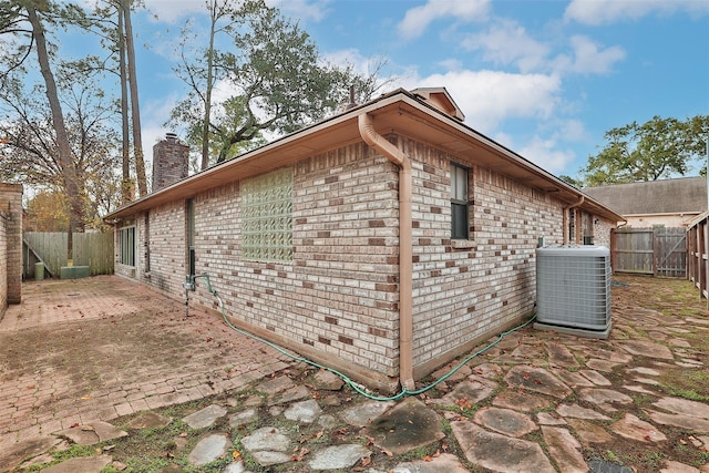 view of property exterior with central AC and a patio area