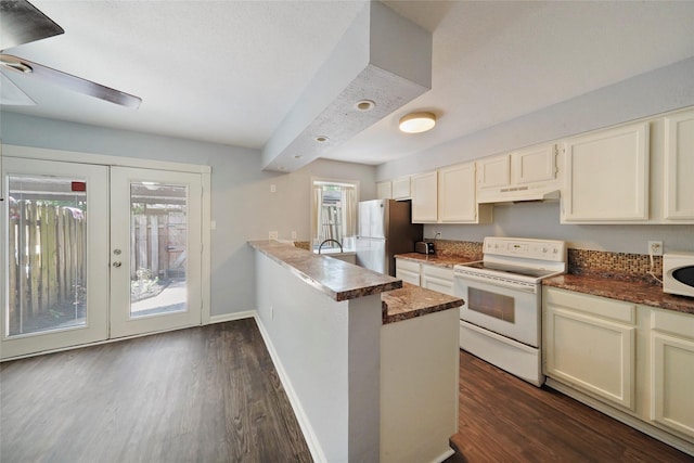 kitchen with kitchen peninsula, french doors, white appliances, ceiling fan, and dark hardwood / wood-style floors