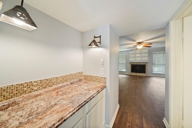 bathroom with hardwood / wood-style flooring and ceiling fan