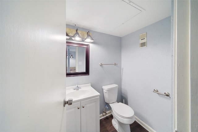 bathroom featuring hardwood / wood-style floors, vanity, and toilet